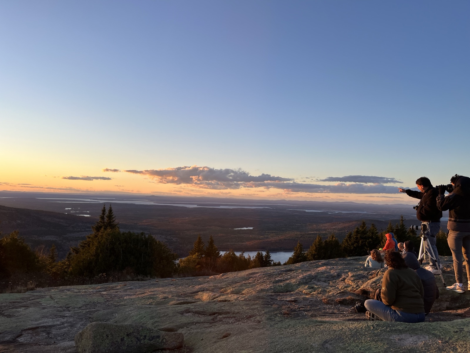 Sunset over the valley from Cadillac Mountain, with hikers watching and photographing