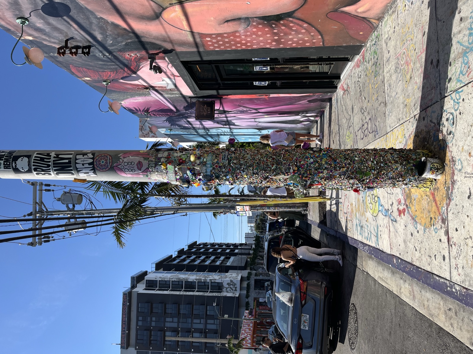Street art and a bottle-cap-covered pole in the Wynwood Arts District, Miami