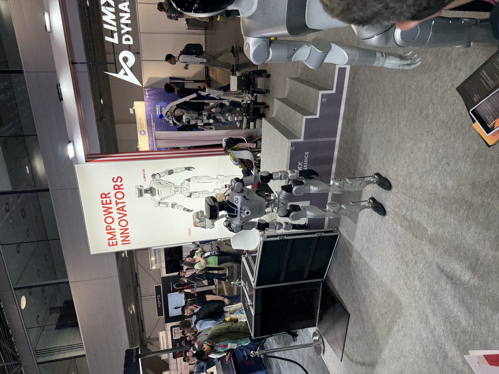 LimX Dynamics' Oli and Tron1 humanoid robots on display at a robotics conference expo