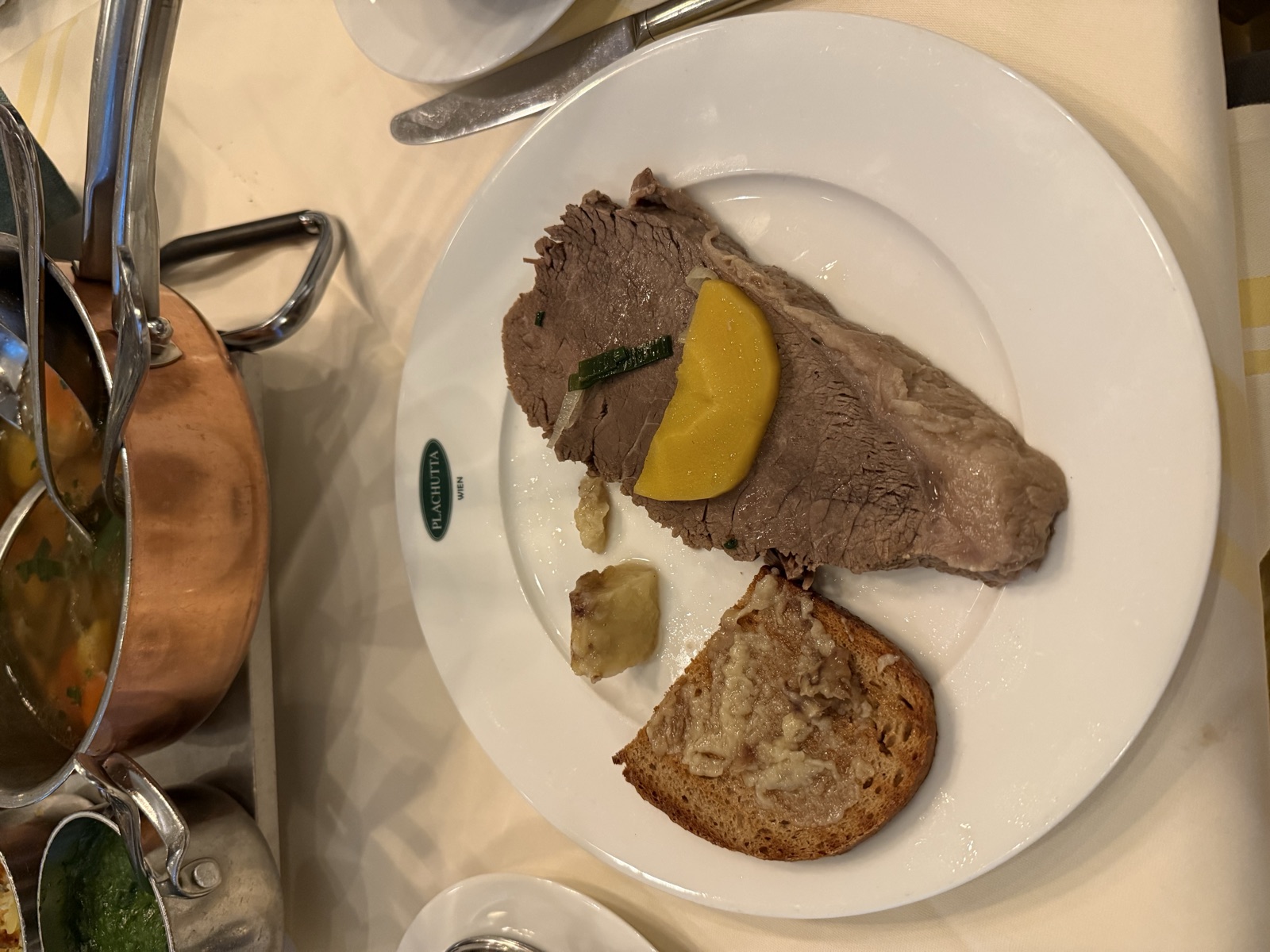 Sliced Tafelspitz beef with bone marrow on toast at Plachutta