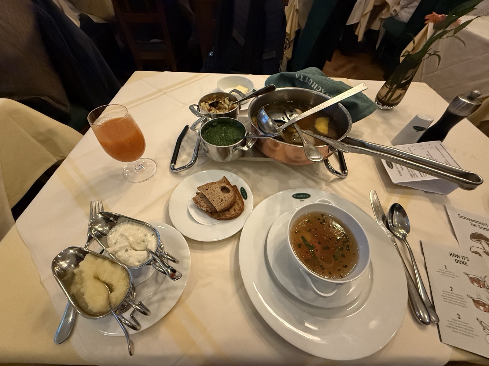 Table setting at Plachutta with the copper broth pot, apple horseradish, and chive sauce